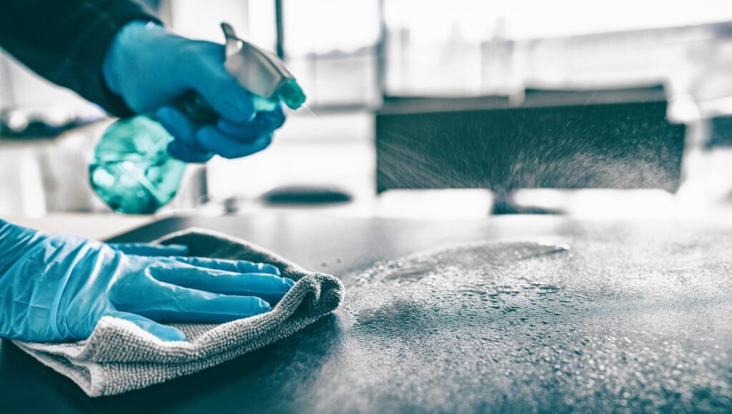 Person cleaning table